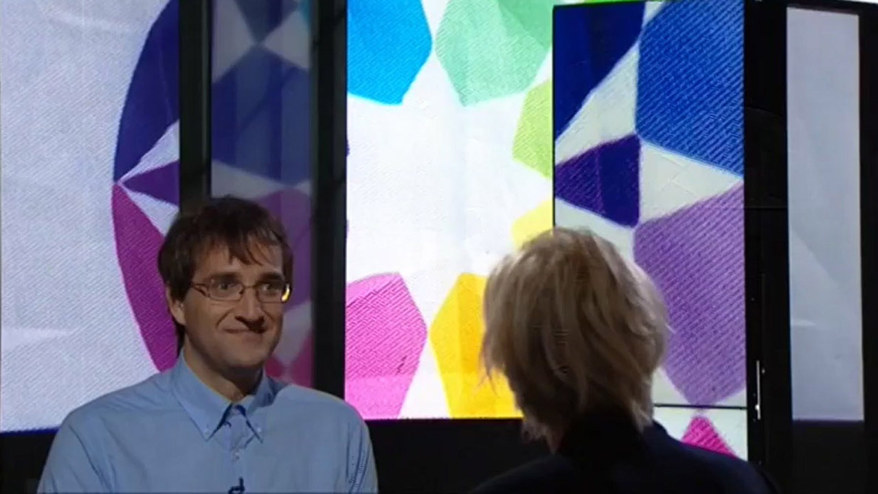 Йозеф Шованец и флаг Аутистана на швейцарском телевидении